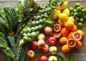 a group of fruits and vegetables on a wood surface Healthy Weight Loss Diets Northamptonshire