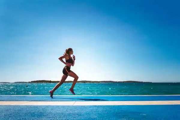 Woman running showing strong leg muscle Northamptonshire